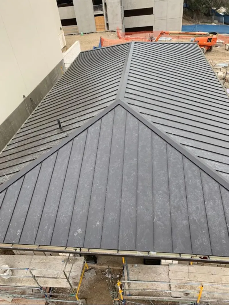 Commercial metal roof construction with crane equipment in La Riviera