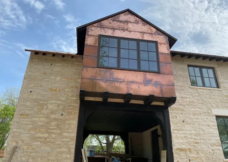 Copper metal panel facade on a stone building for Skylight Installation in La Riviera